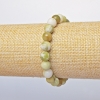 Bracelet jadéite jaune (pressé) perles lisses, diamètre 9 mm +/-, longueur 18 cm +/- (élastique)