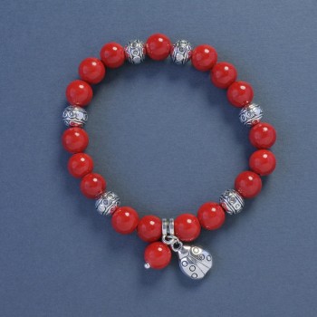 Bracelet en corail (pressé), diamètre 9 mm ±, longueur 18 cm ±, élastique avec pendentif coccinelle